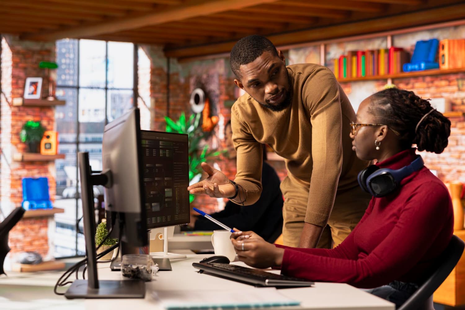African developer working on laptop in a modern workspace